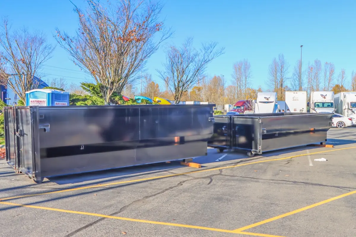 Professional dumpster rental service with roll-off container on residential driveway in Hueytown